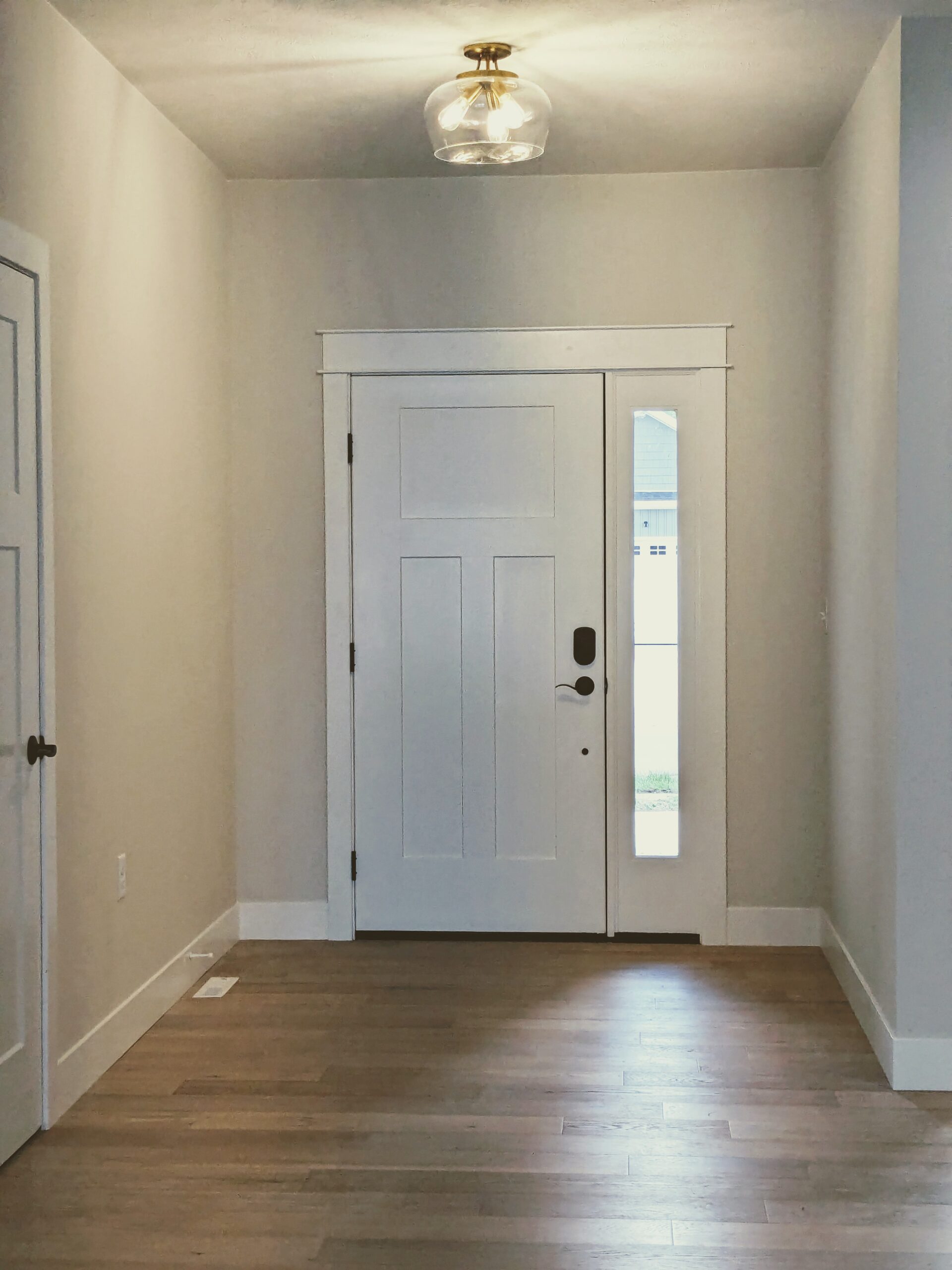 A white wall with a black and red sign on it