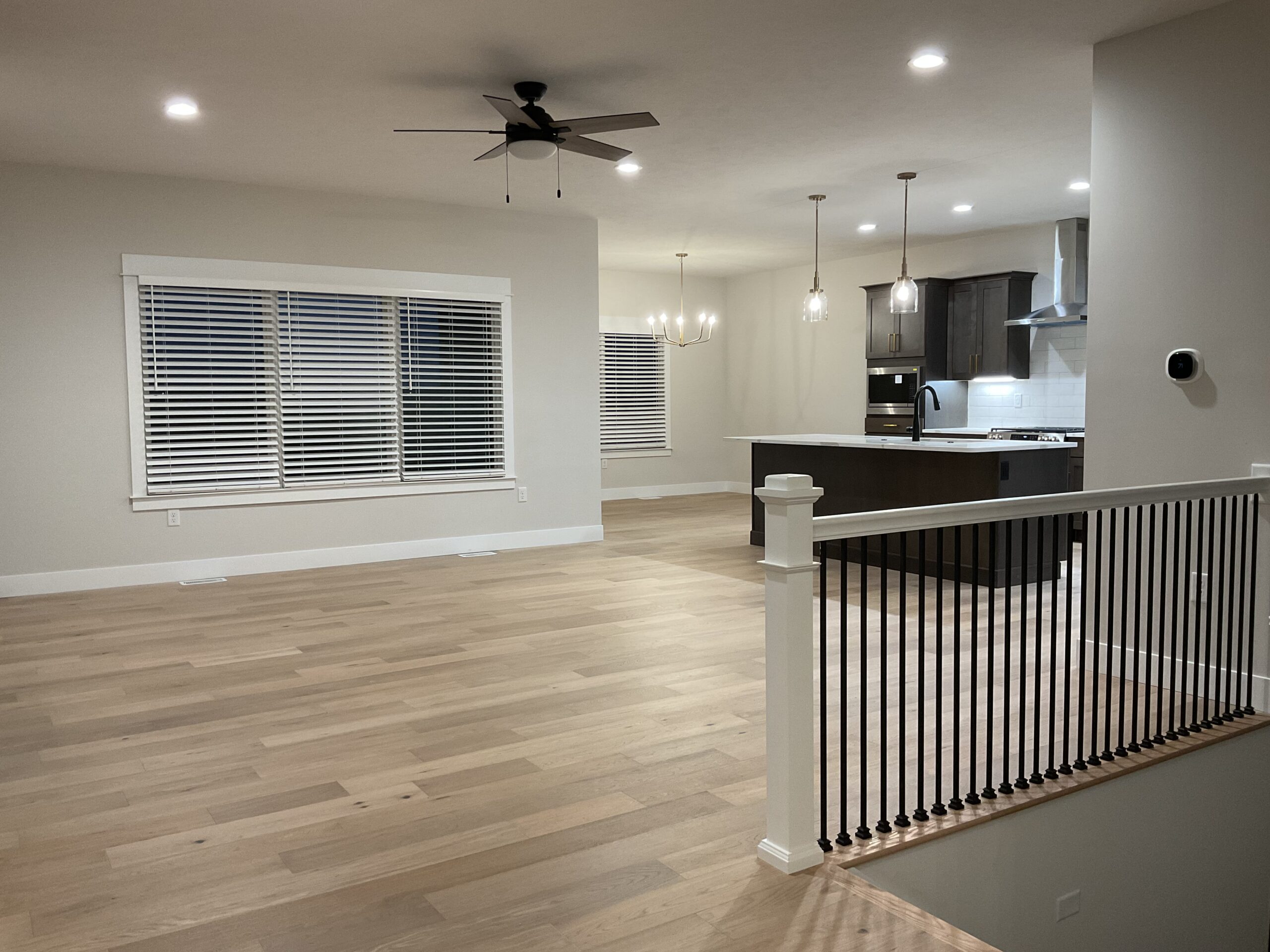Living Room with Stairwell and Kitchen view
