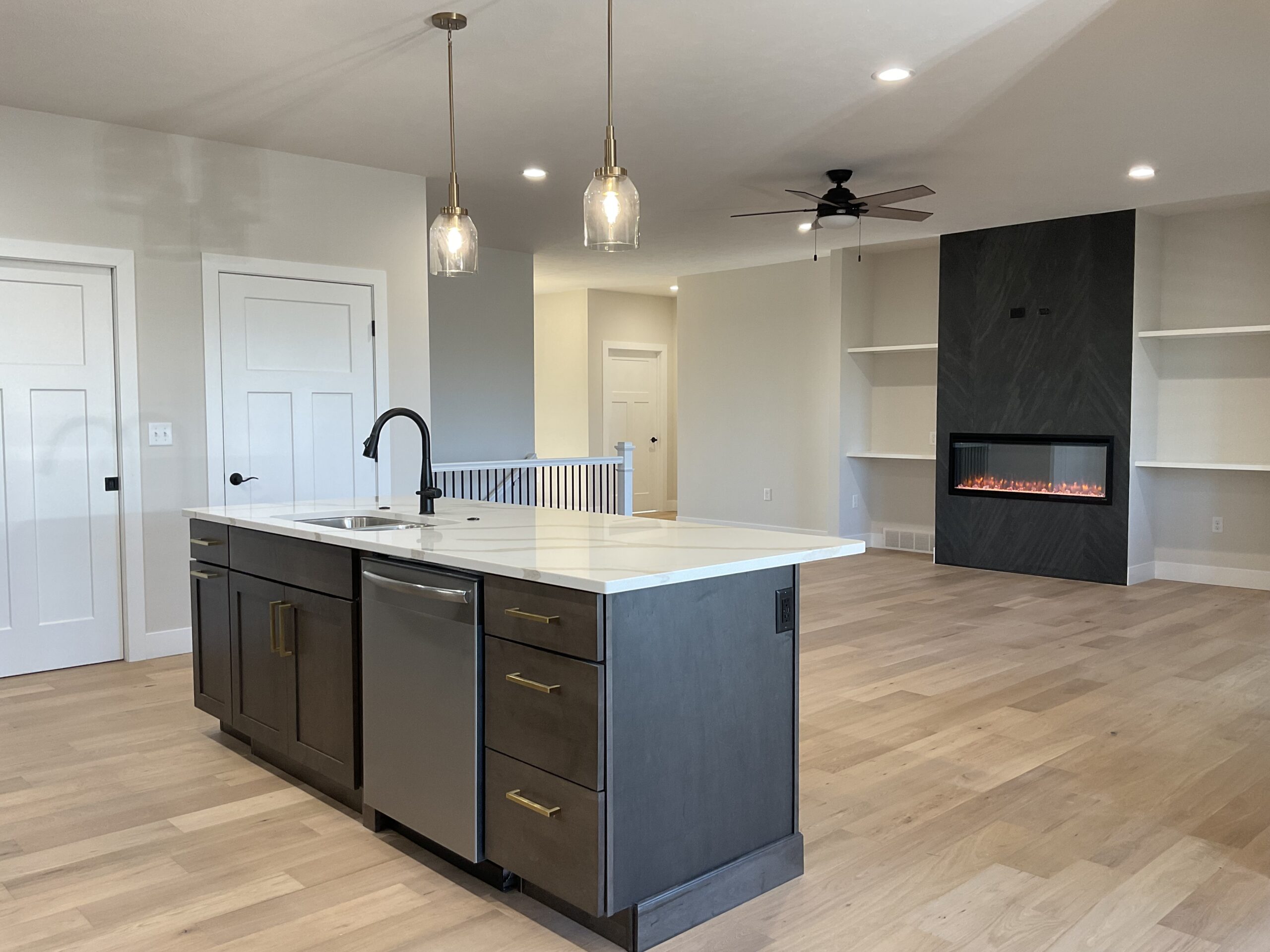 Island to Living Room with Fireplace, adaptable sink base and touch faucet.